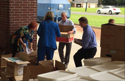 Group of people organizing boxes of donations