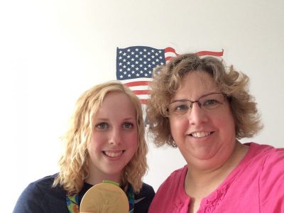 Mother with daughter holding Olympic gold medal