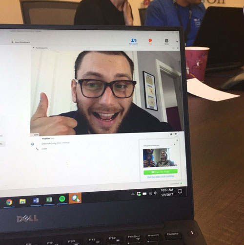 Laptop screen showing man on video call