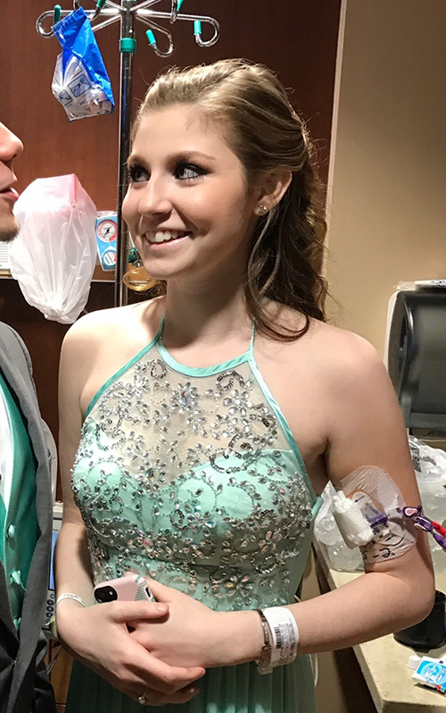 Female hospital patient wearing prom dress