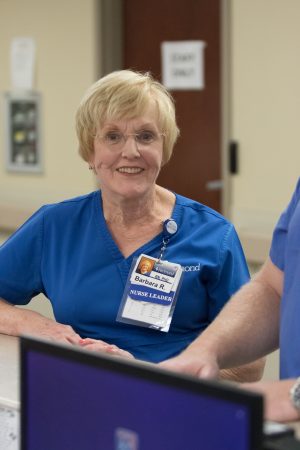 Female nurse wearing blue scrubs