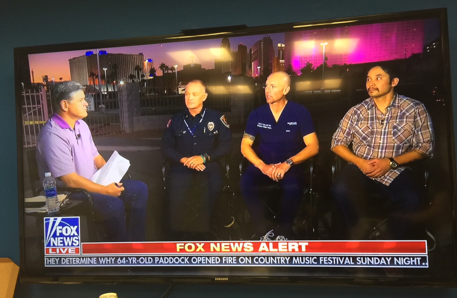 Three male hospital caregivers appearing on TV news segment with show host