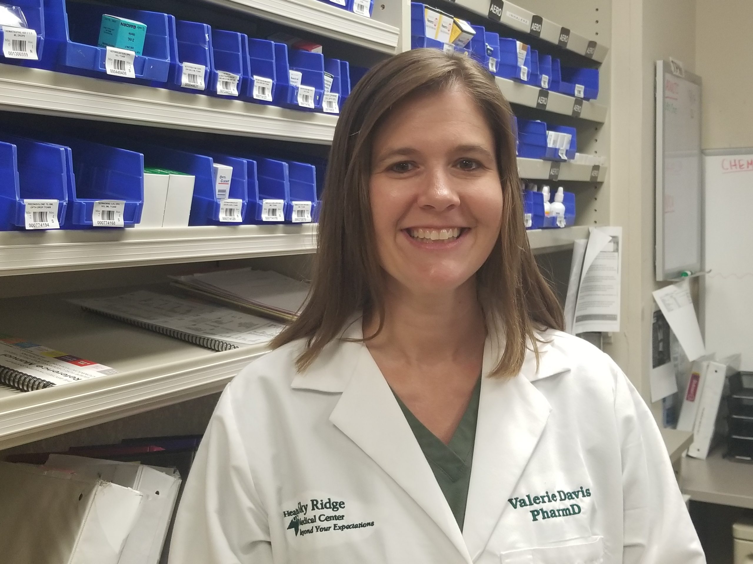 Female pharmacist wearing white lab coat