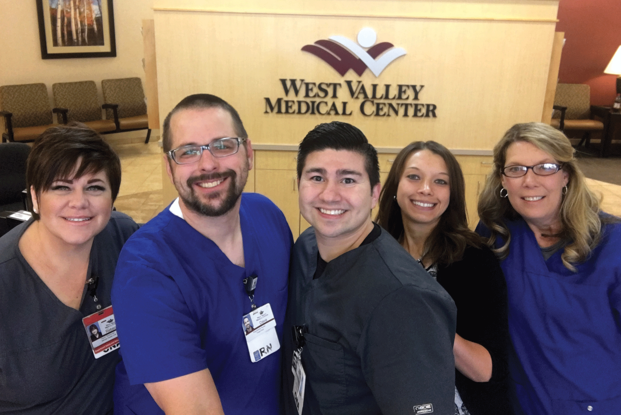 Five hospital caregivers standing in front of a West Valley Medical Center sign