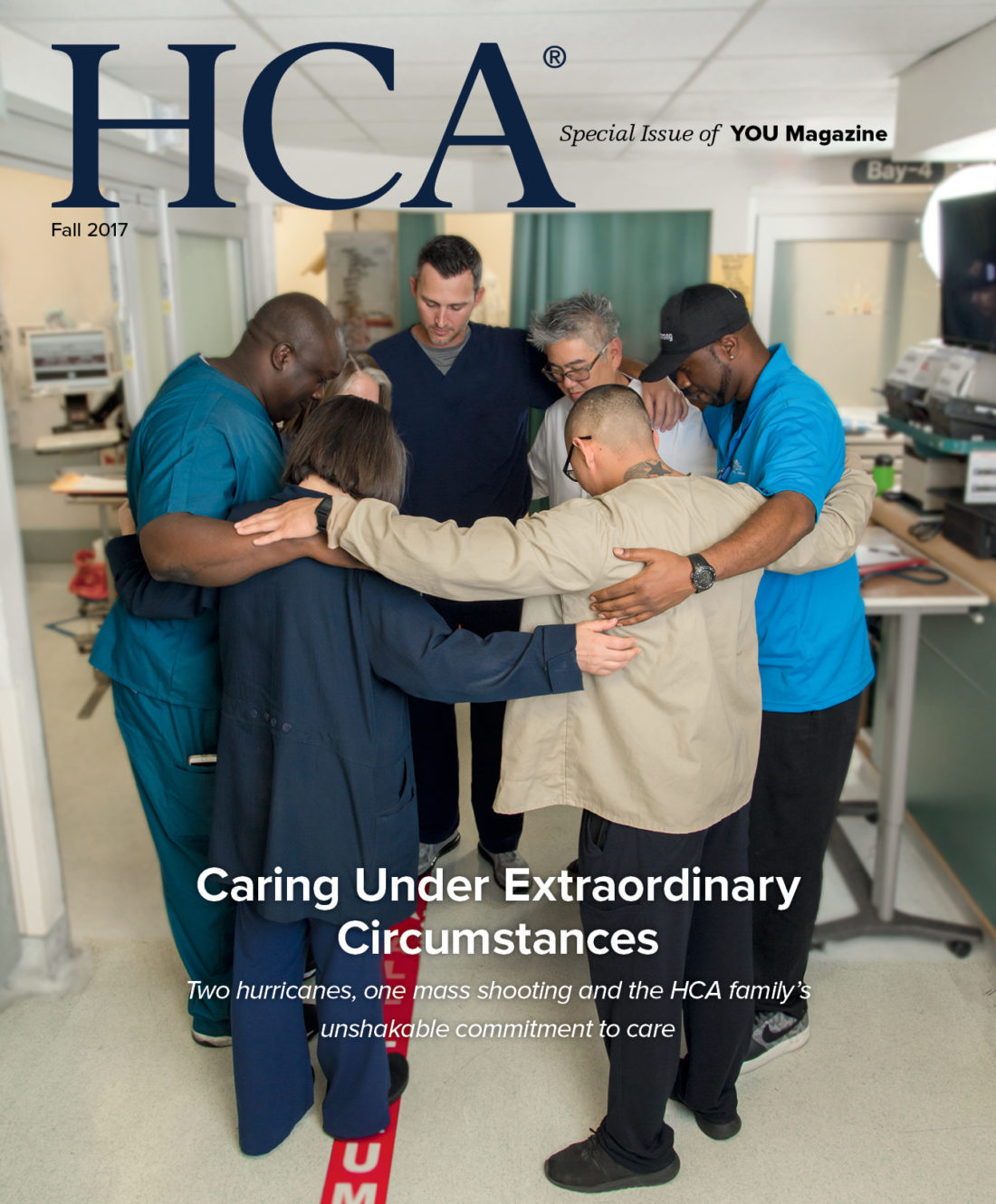 Magazine cover with photo of seven hospital caregivers circled together with arms around each other