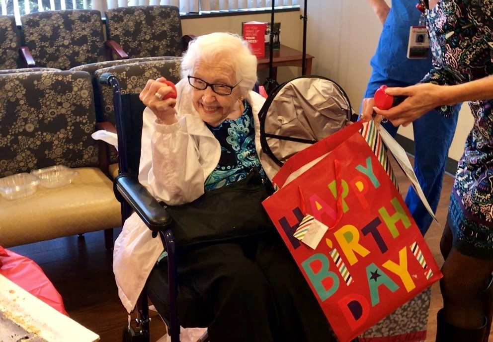 99-year-old woman opening birthday present