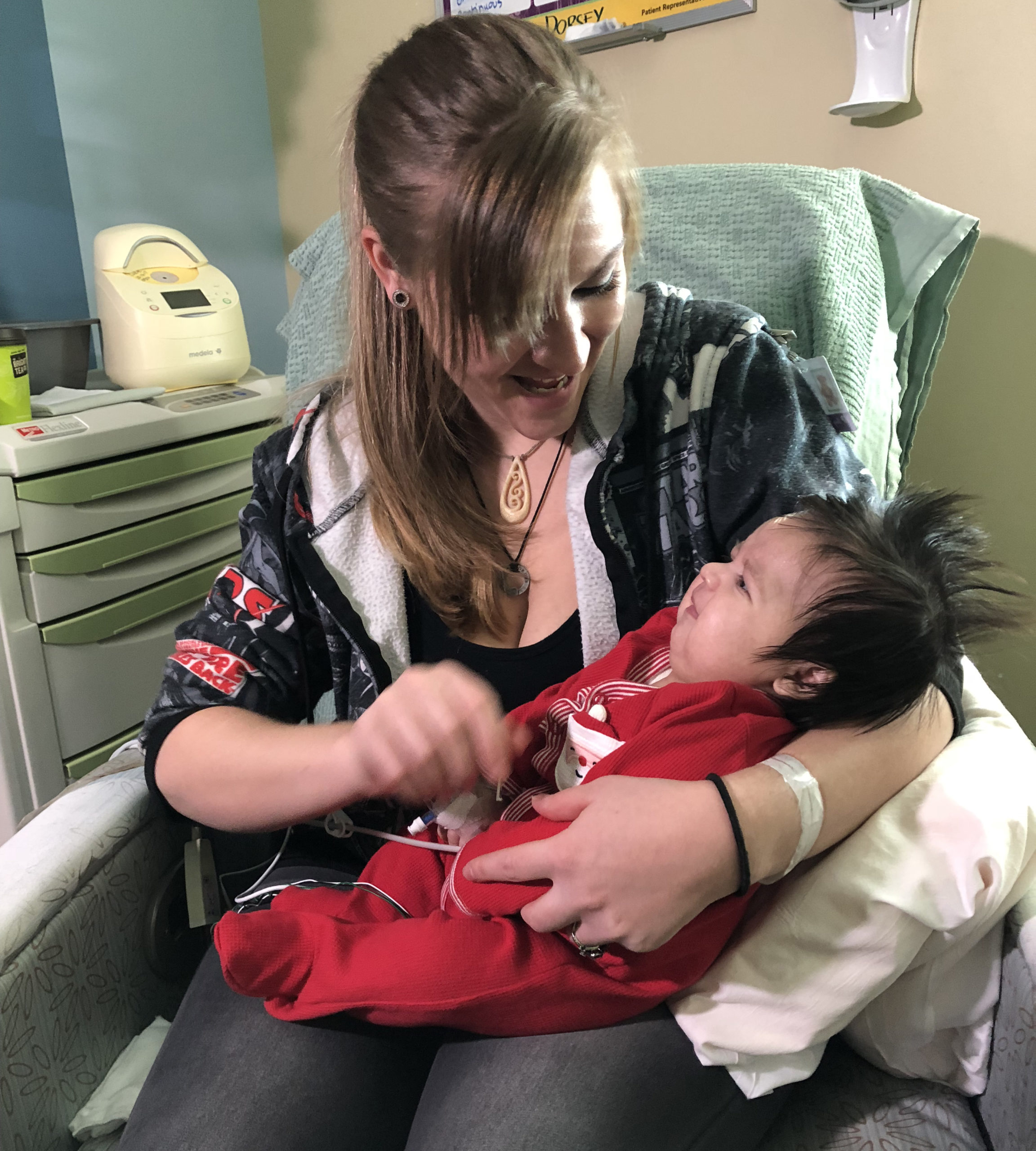 Woman holding baby in hospital room