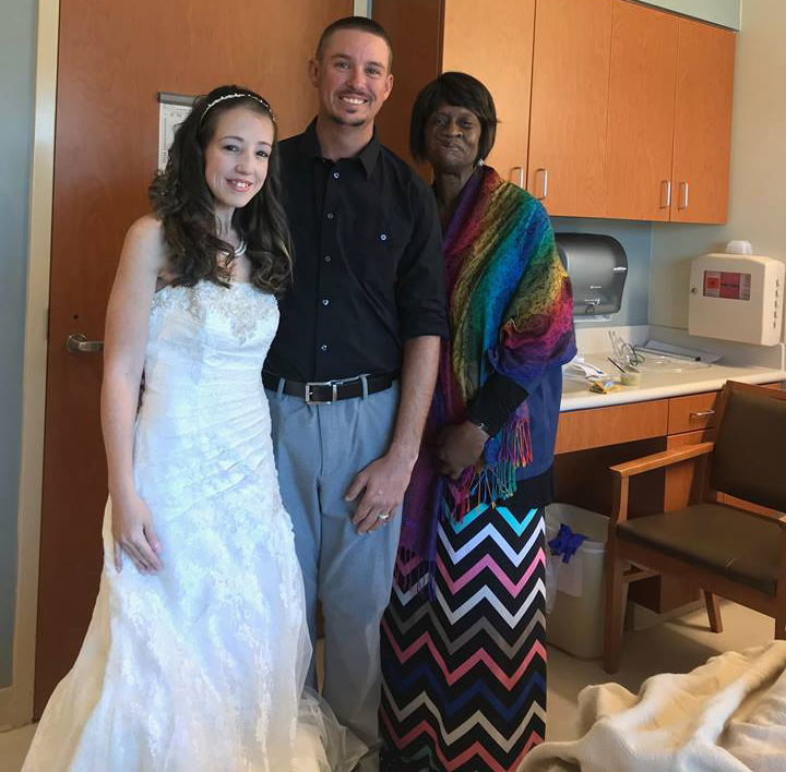 Bride and groom with hospital chaplain 