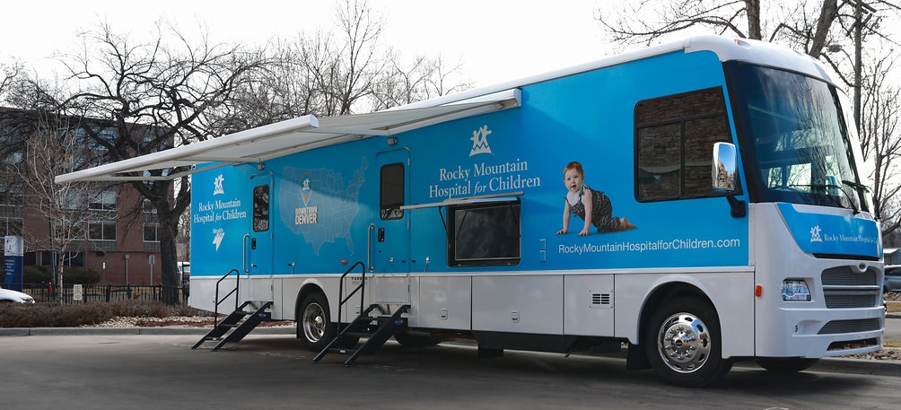 Blue and white RV used as mobile training center