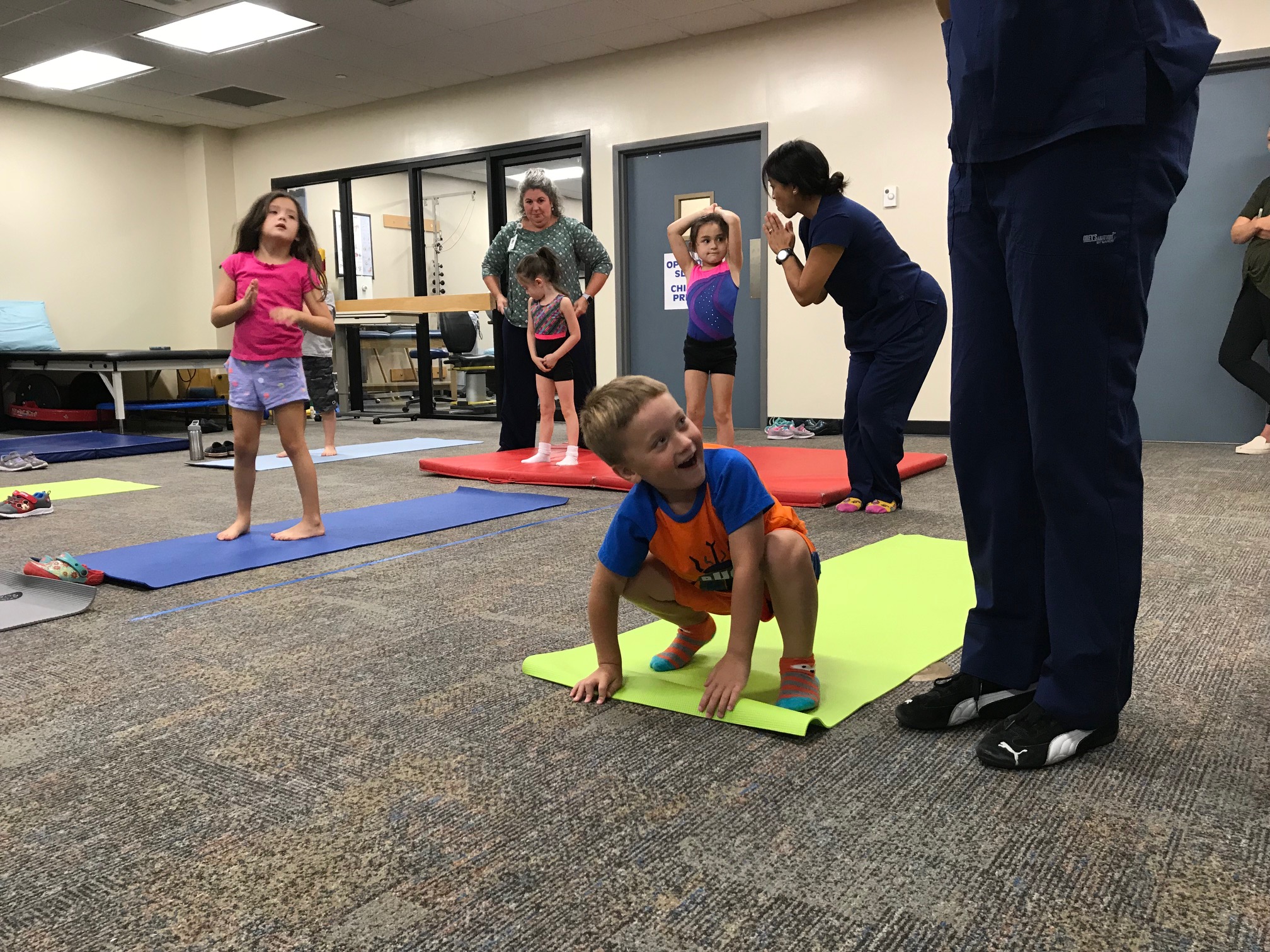 Physical therapists leading a kids yoga class