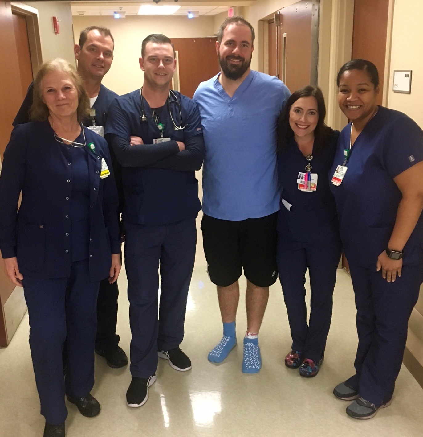 Five nurses with a male patient