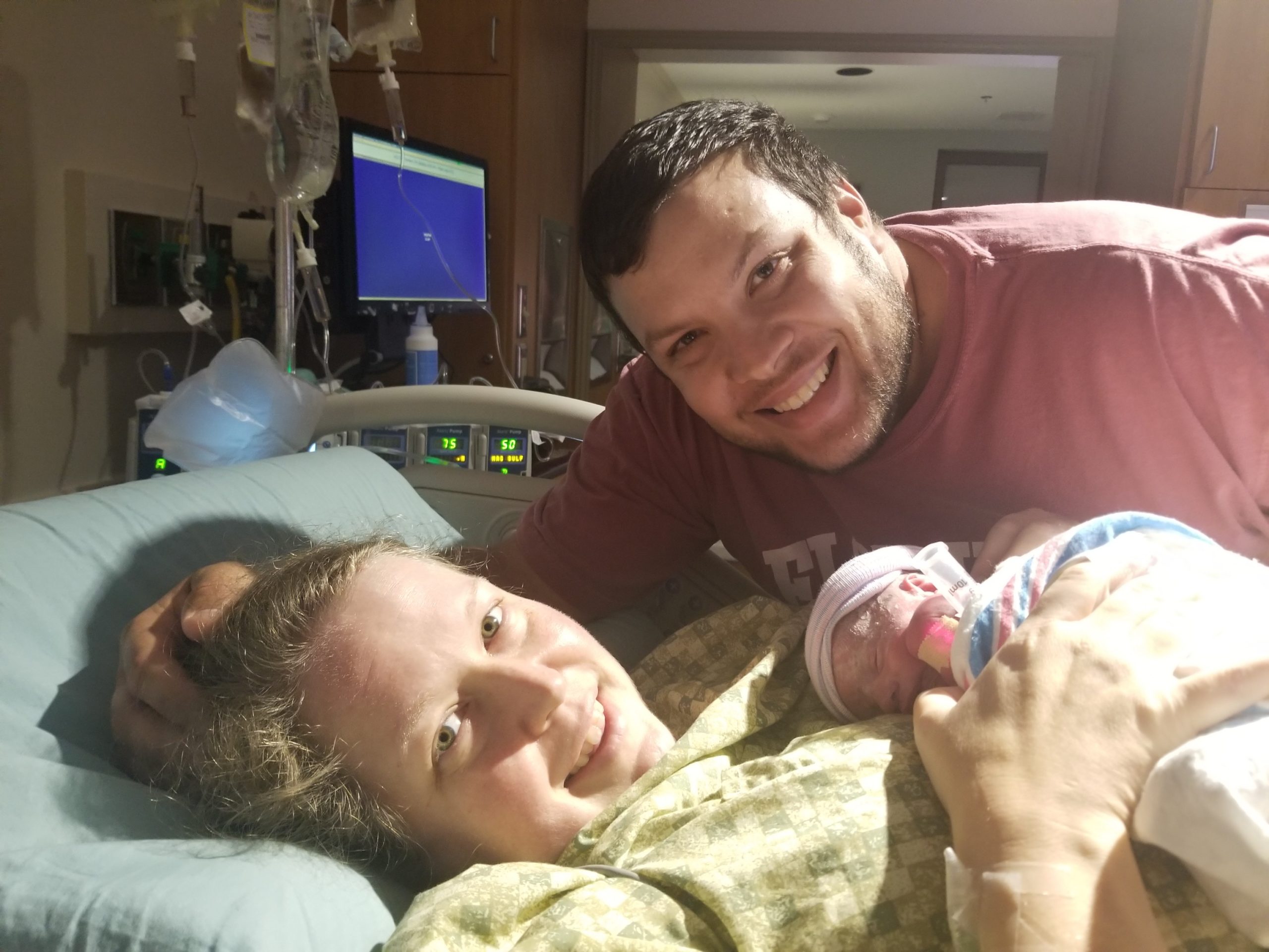 Mom and dad with newborn baby in hospital