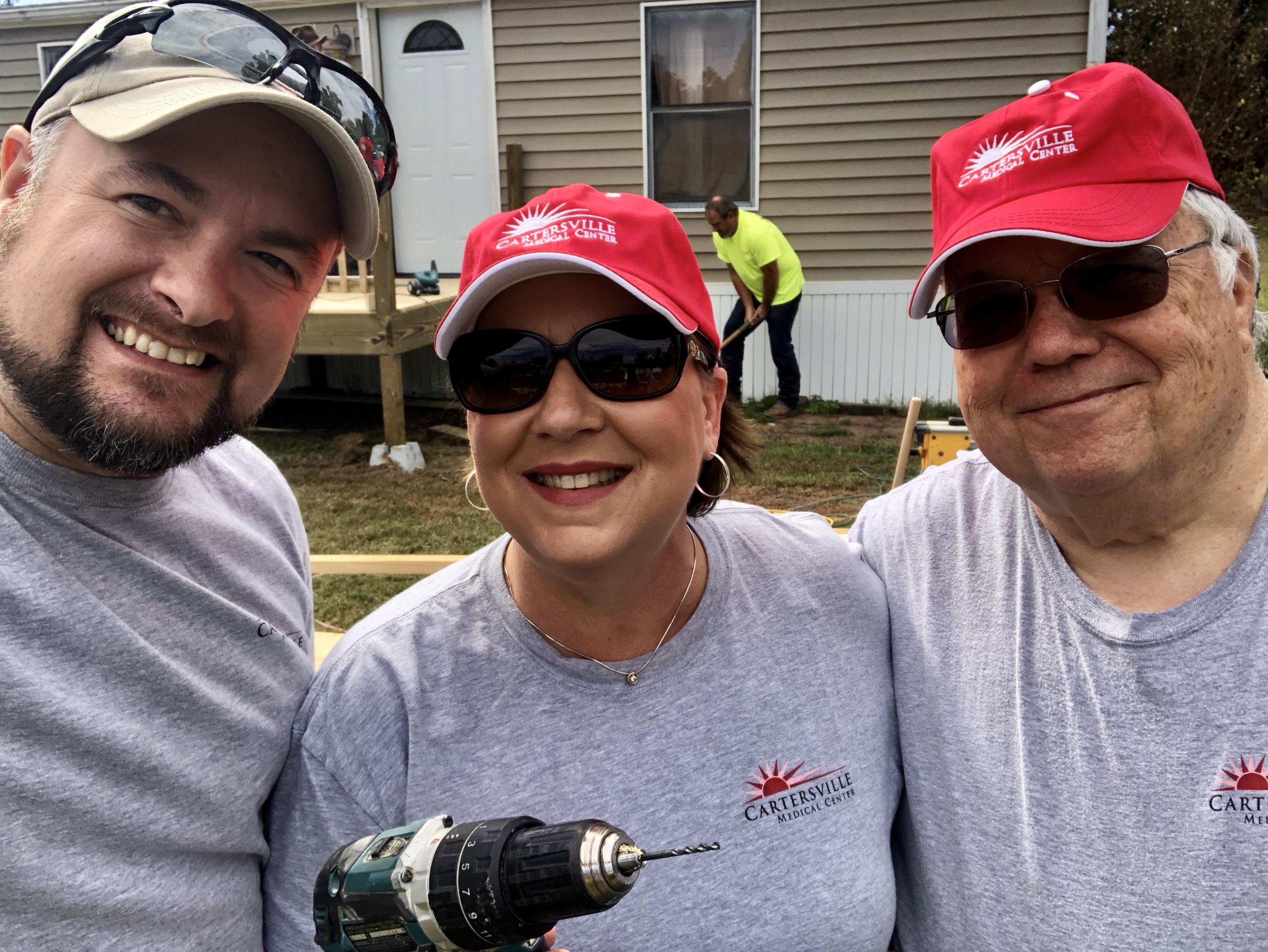 Three volunteers at a home renovation site