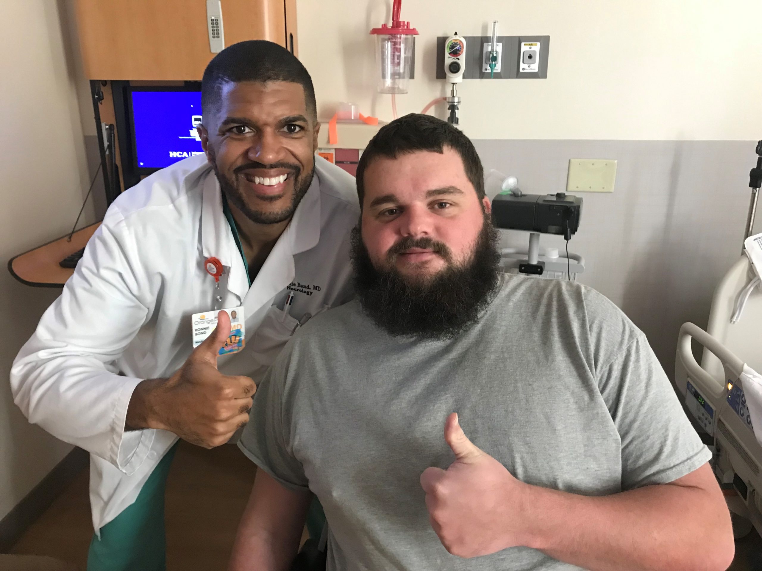 A male doctor and a male patient giving thumbs up sign