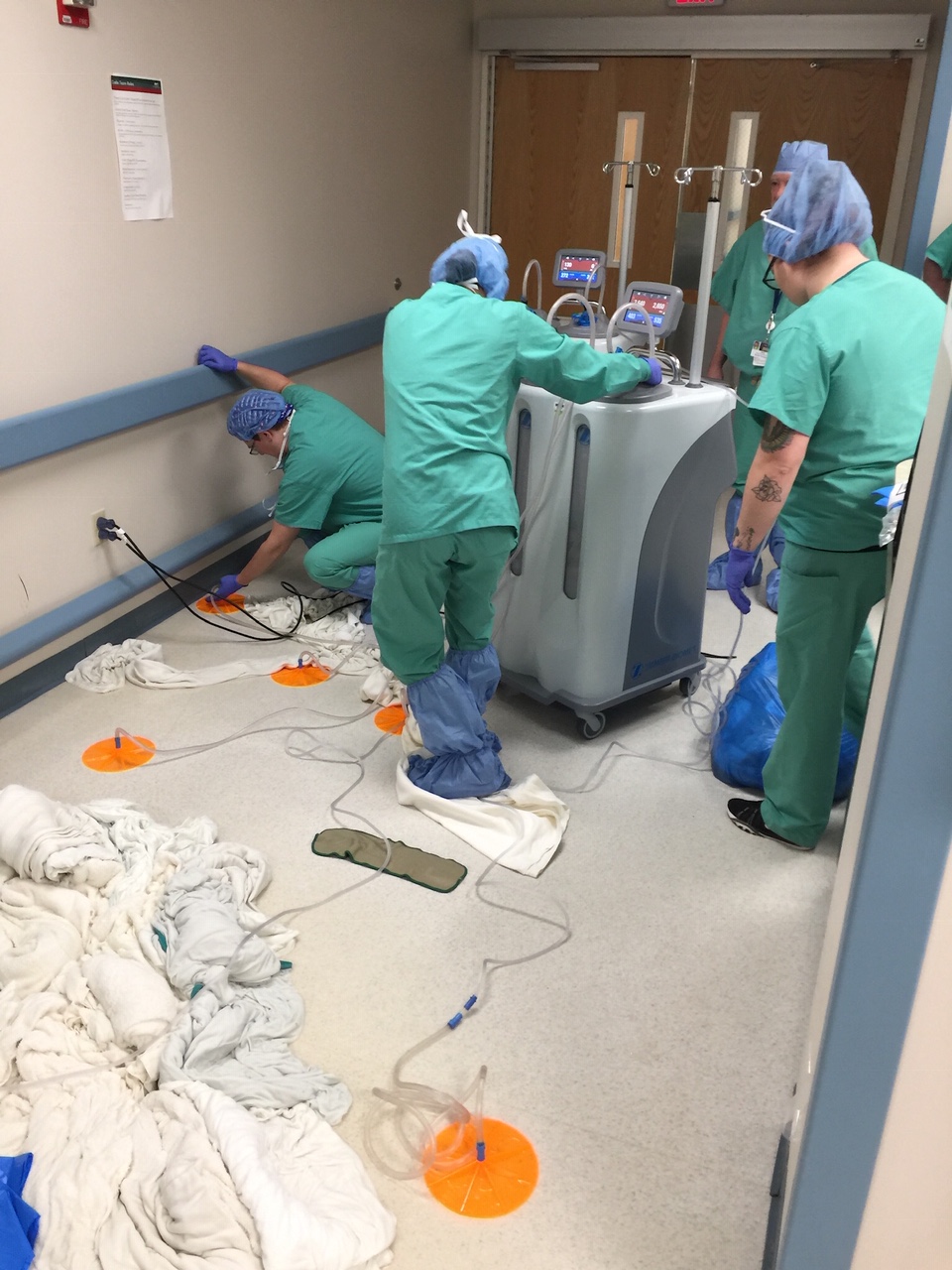Hospital staff cleaning up hallway after earthquake
