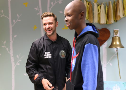 Justin Timberlake laughing with a young cancer patient