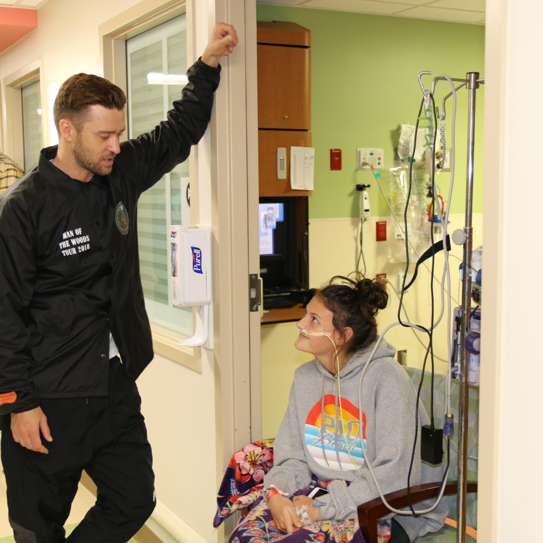 Justin Timberlake talking to a young cancer patient