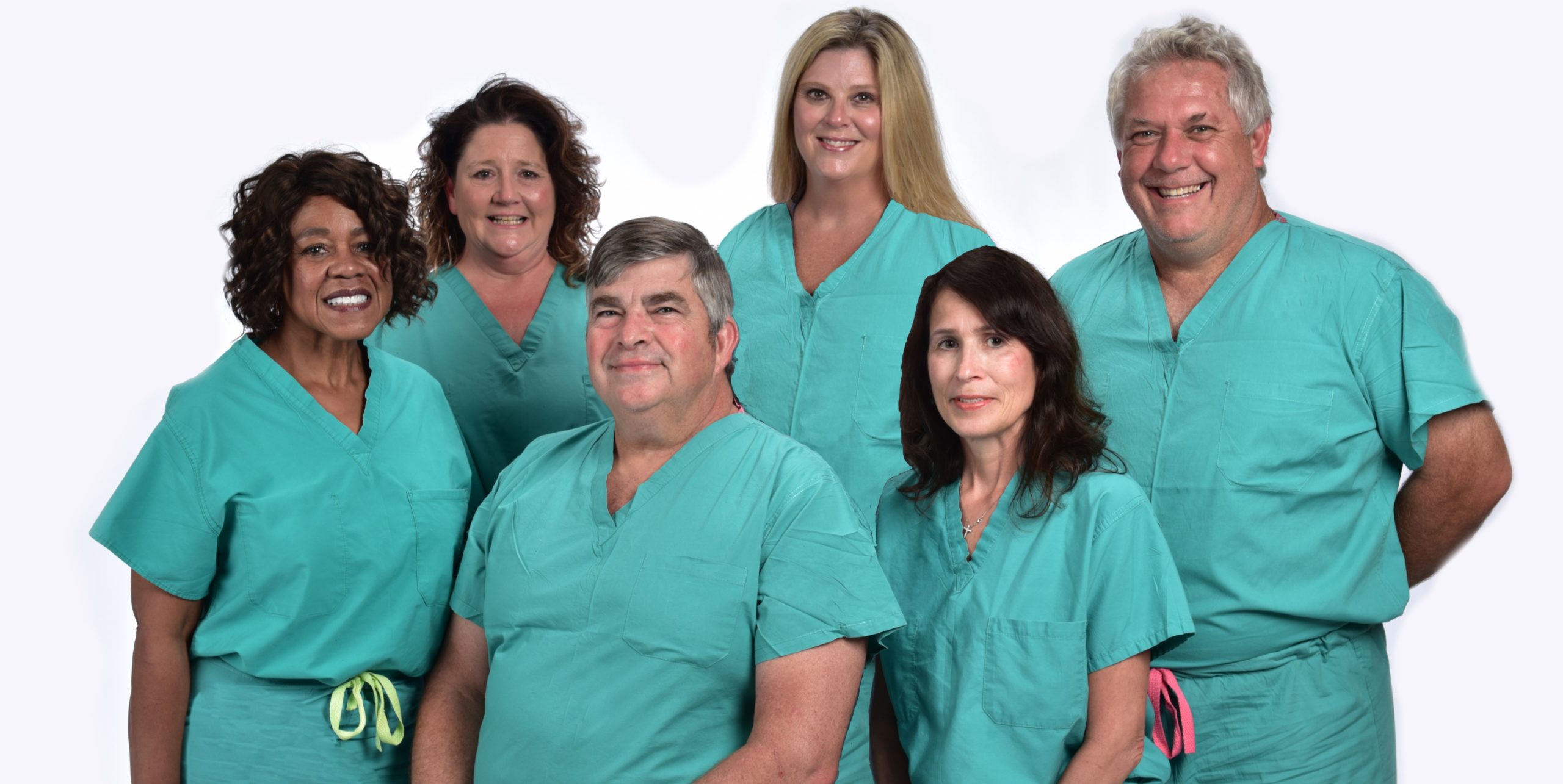 Group of doctors and nurses wearing green scrubs