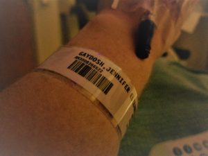 Arm with hospital ID bracelet and IV