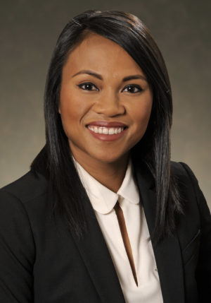 Woman in suit. Headshot of Reynaria Pitts.