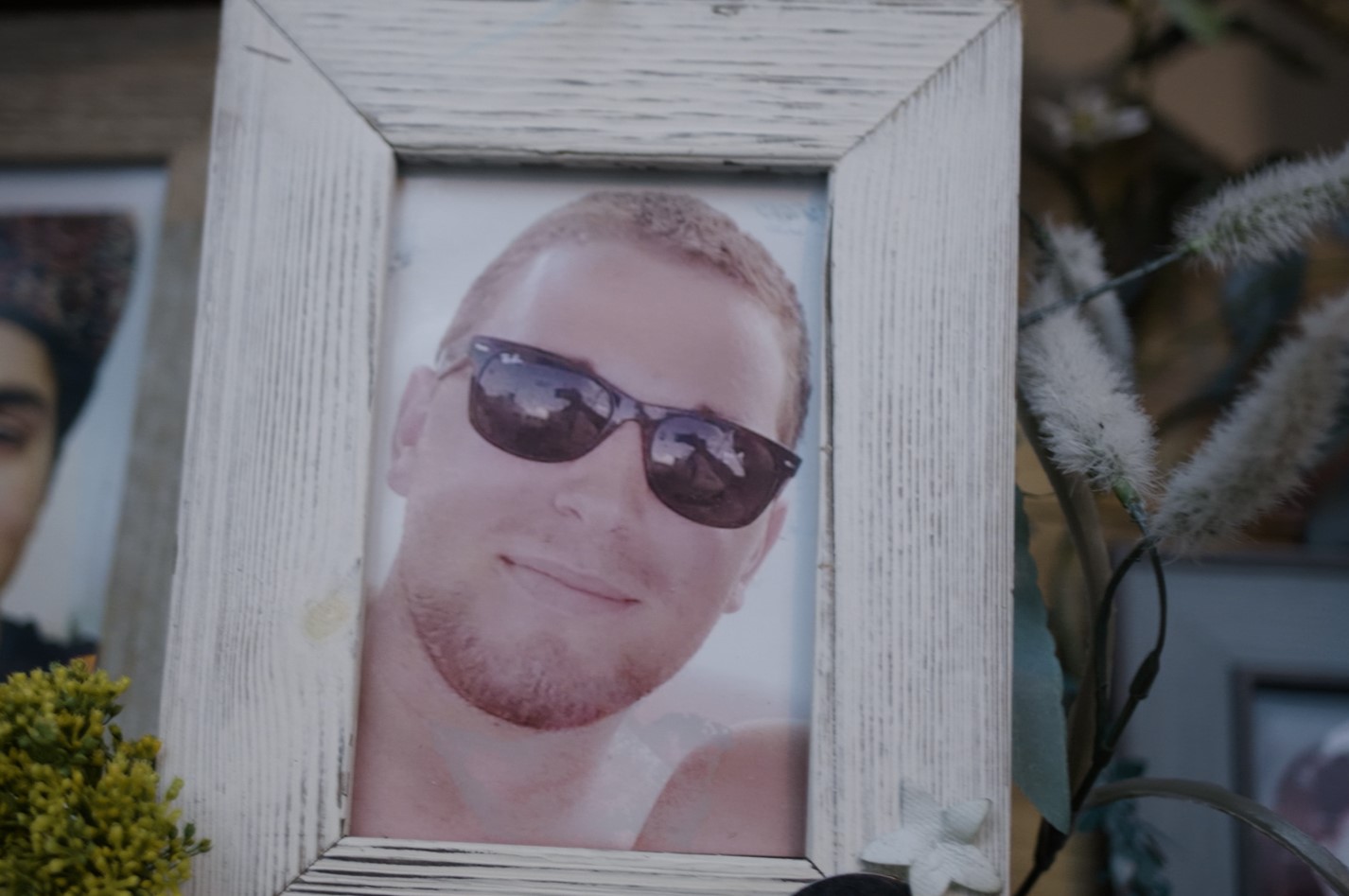 A framed photo of a man wearing sunglasses
