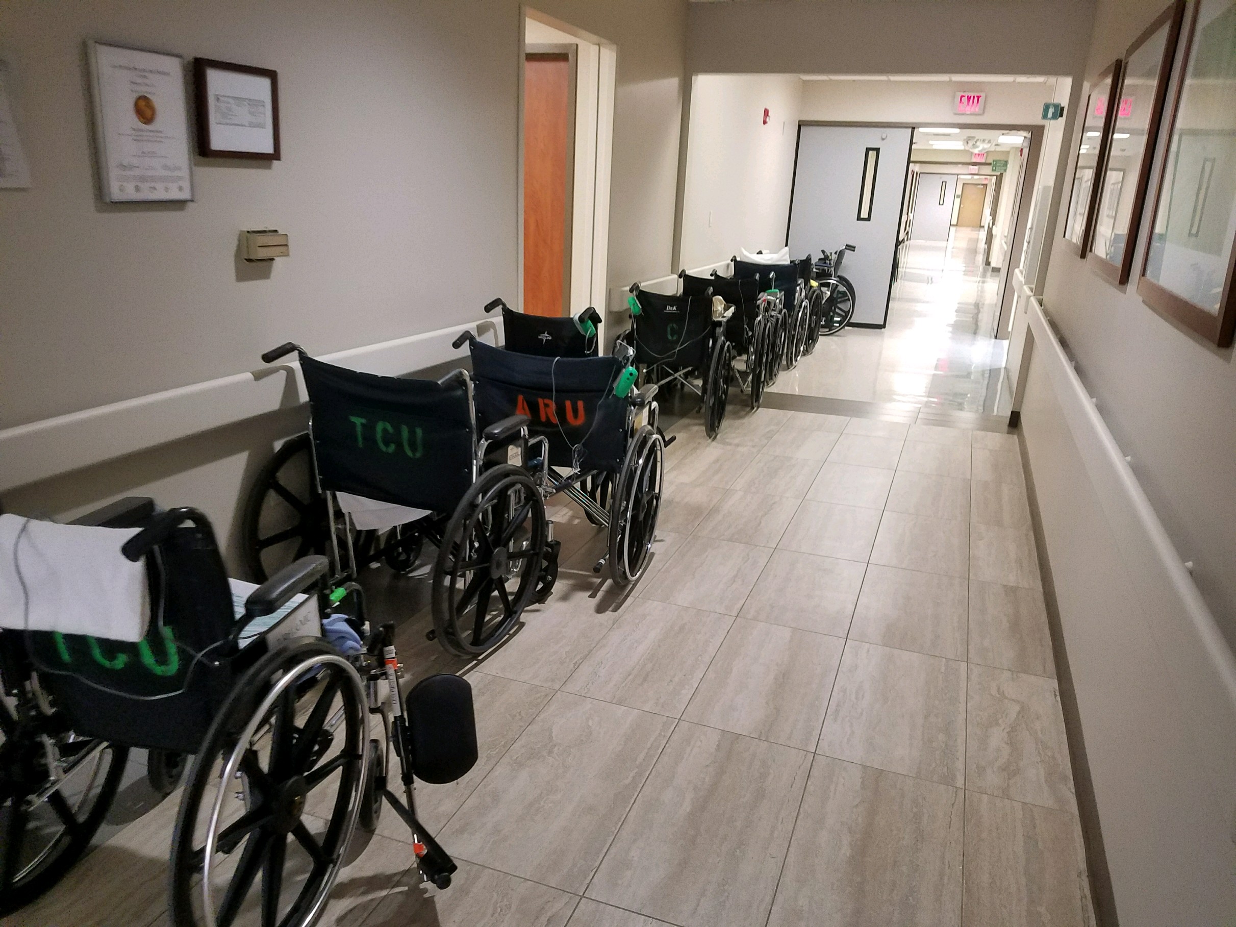 Wheelchairs lined up along a hospital hallway