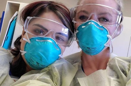 Closeup of two female nurses wearing personal protective equipment