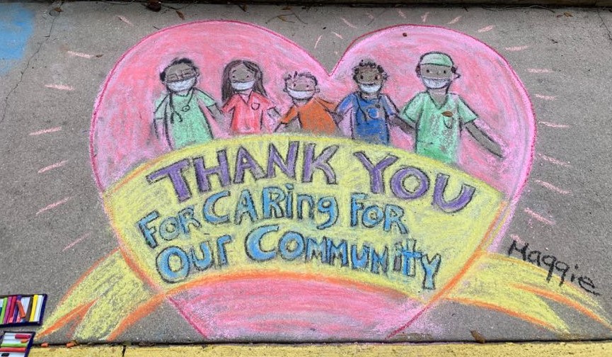 A chalk art drawing that says Thank You for Caring for Our Community
