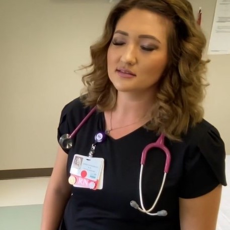 Nurse Jessica Hanamoto wearing scrubs, standing with eyes closed