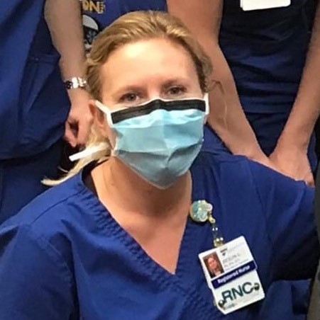Headshot of nurse Jocelyn Grobmeier in scrubs and protective face mask