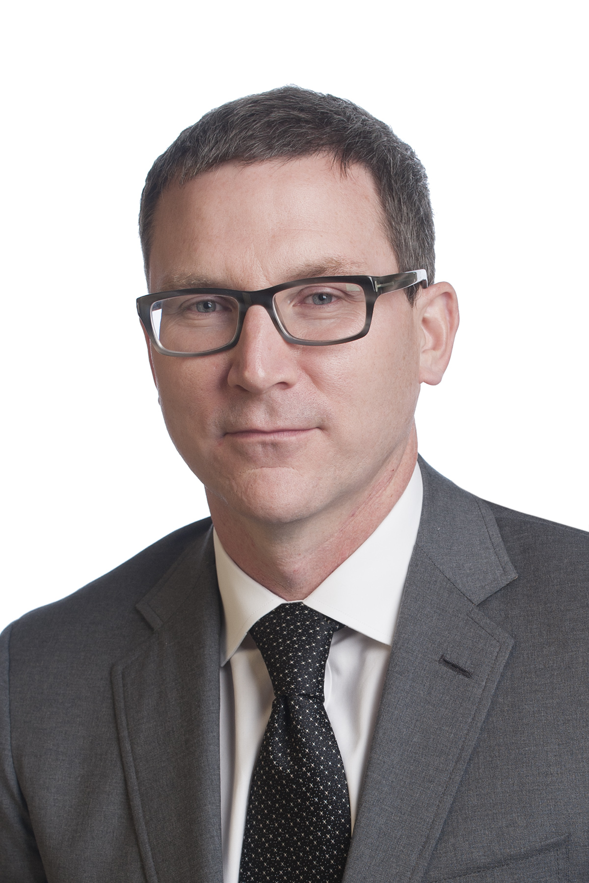 Man in suit and tie wearing glasses. Headshot of Dr. Matt Mulloy.
