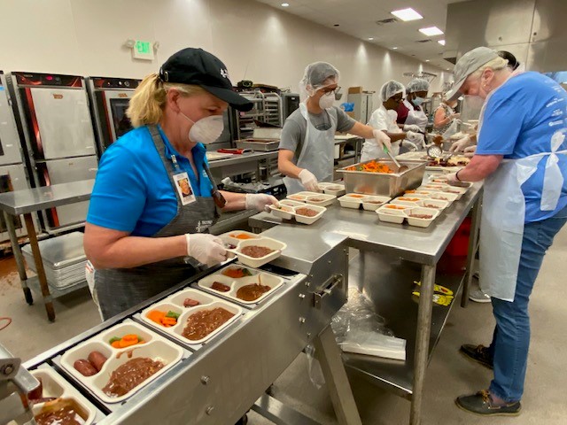 Volunteers preparing meals at Second Harvest Food Bank of Greater New Orleans and Acadiana