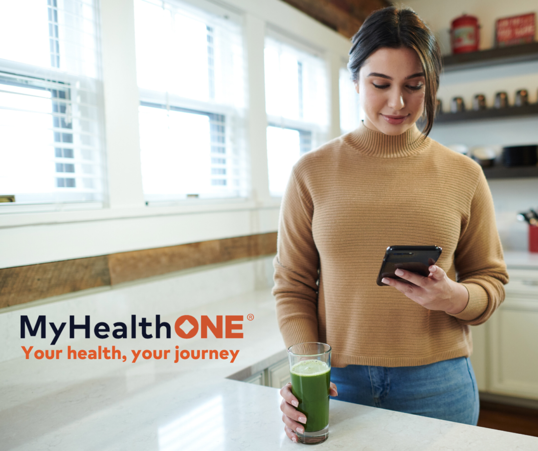 Woman holding cell phone using the MyHealthOne app