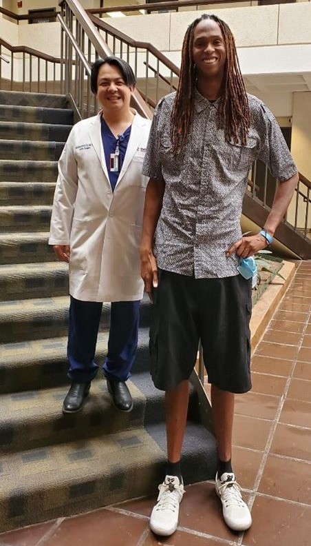 Dr. Kim de la Cruz standing indoors with Jay Middleton 