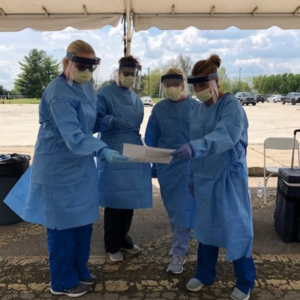 Four women wearing personal protective equipment 