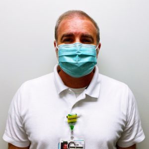 Male nurse wearing a face mask. Headshot of Rob Ward.