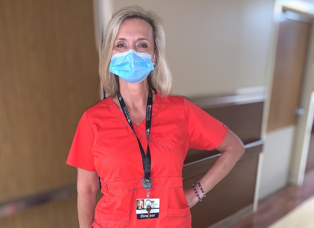 Woman wearing face mask and scrubs