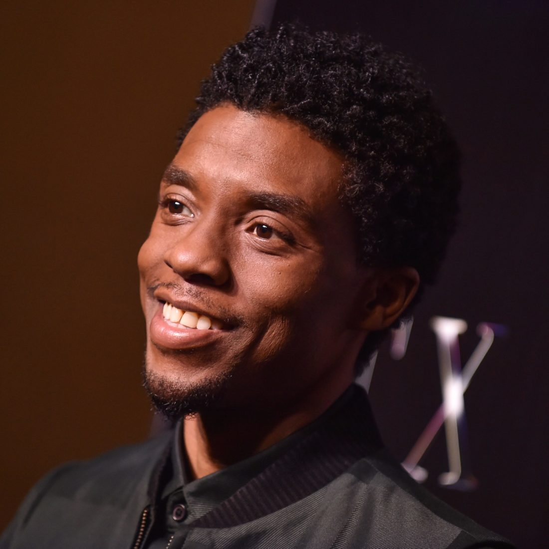 Chadwick Boseman smiling during red carpet event