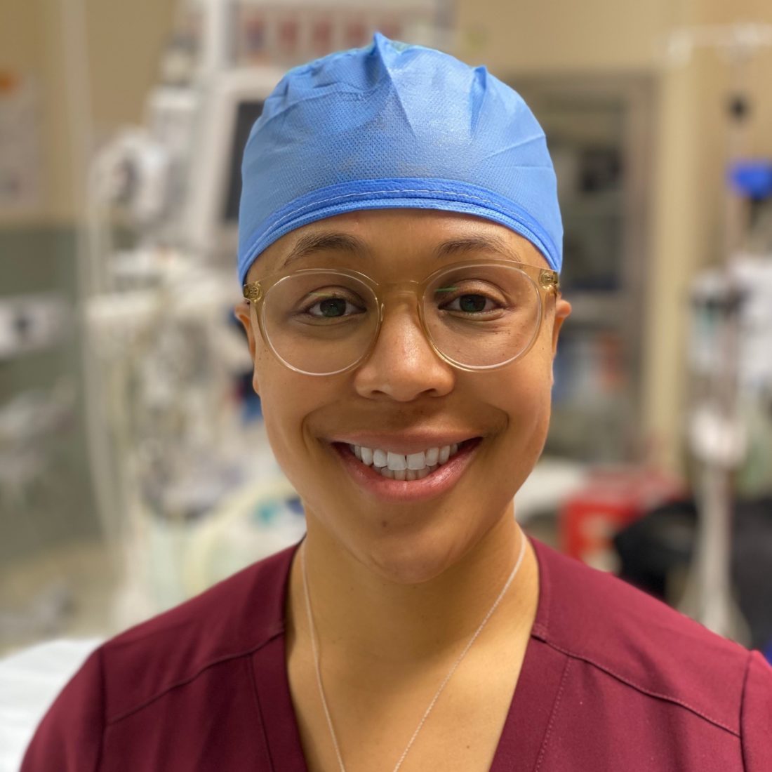 Female doctor wearing scrub cap and glasses. Headshot of Dr. Shasta Henderson. 