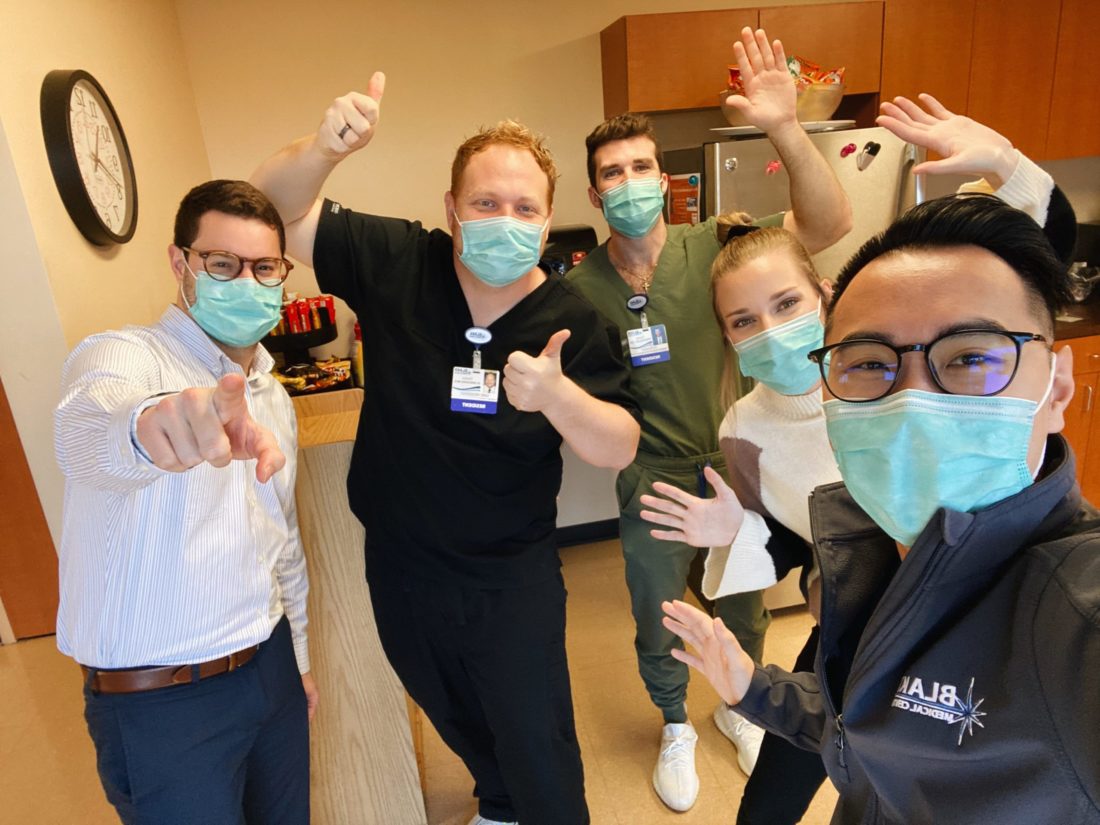 Five resident physicians wearing face masks. 