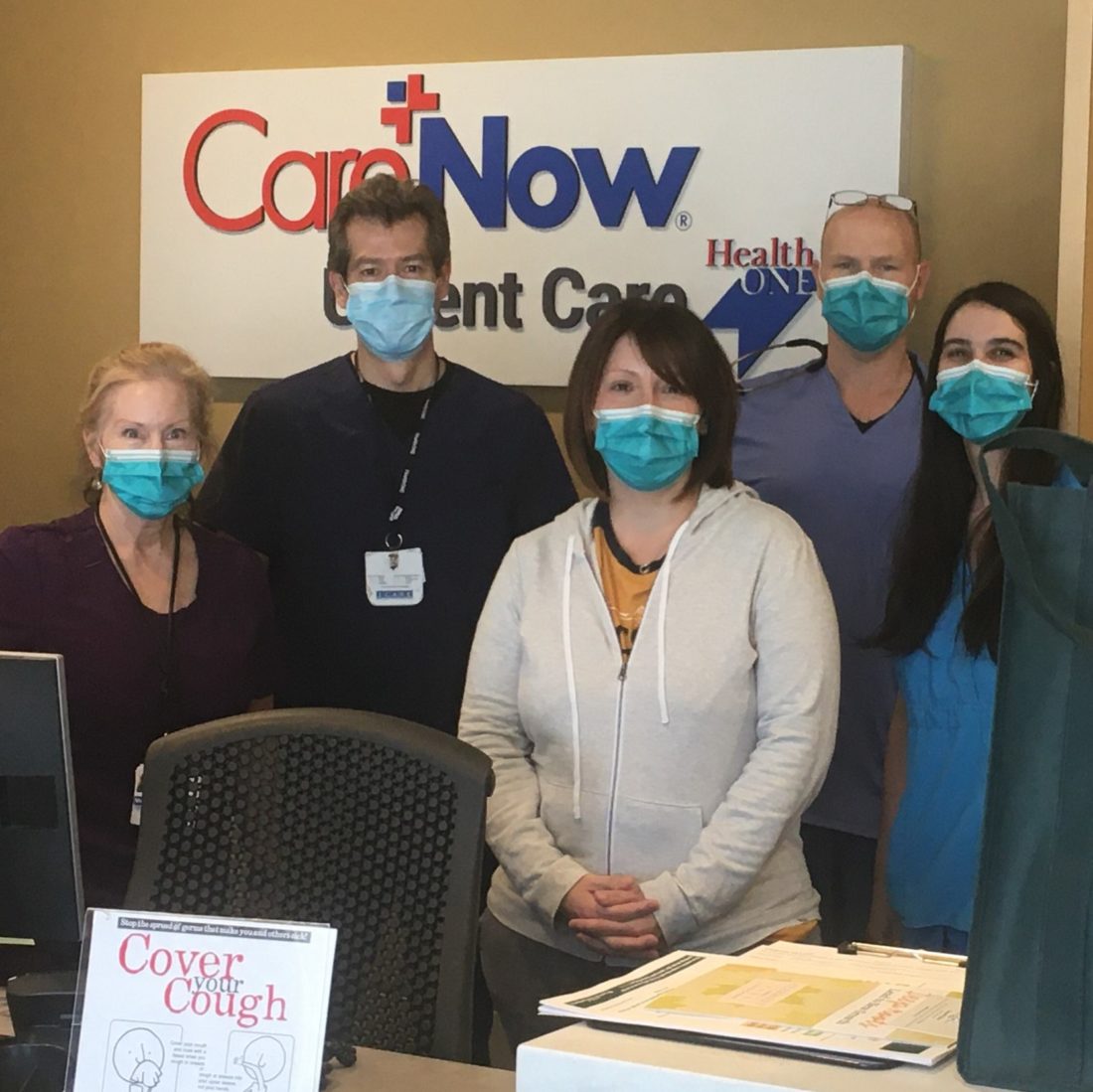 Five urgent care employees wearing face masks