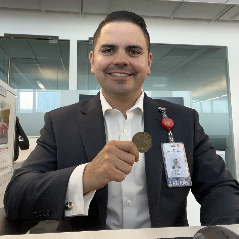 Rich Veloz holding a challenge coin