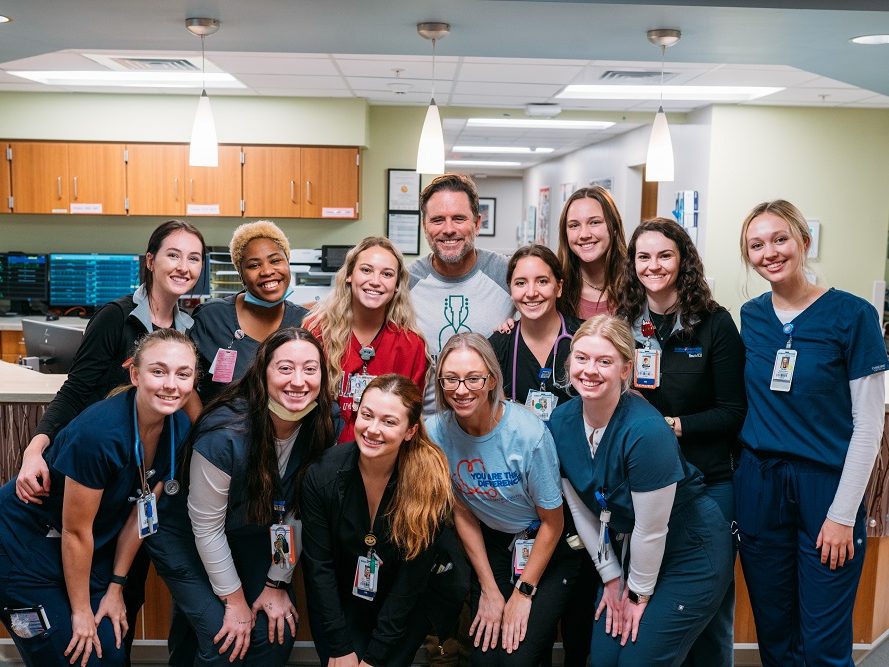 HCA Healthcare colleagues smile for picture with Charles Esten. 