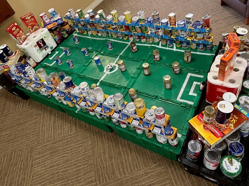 Donated canned food organized to look like a soccer field. 