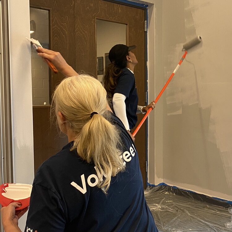 volunteers painting a wall 