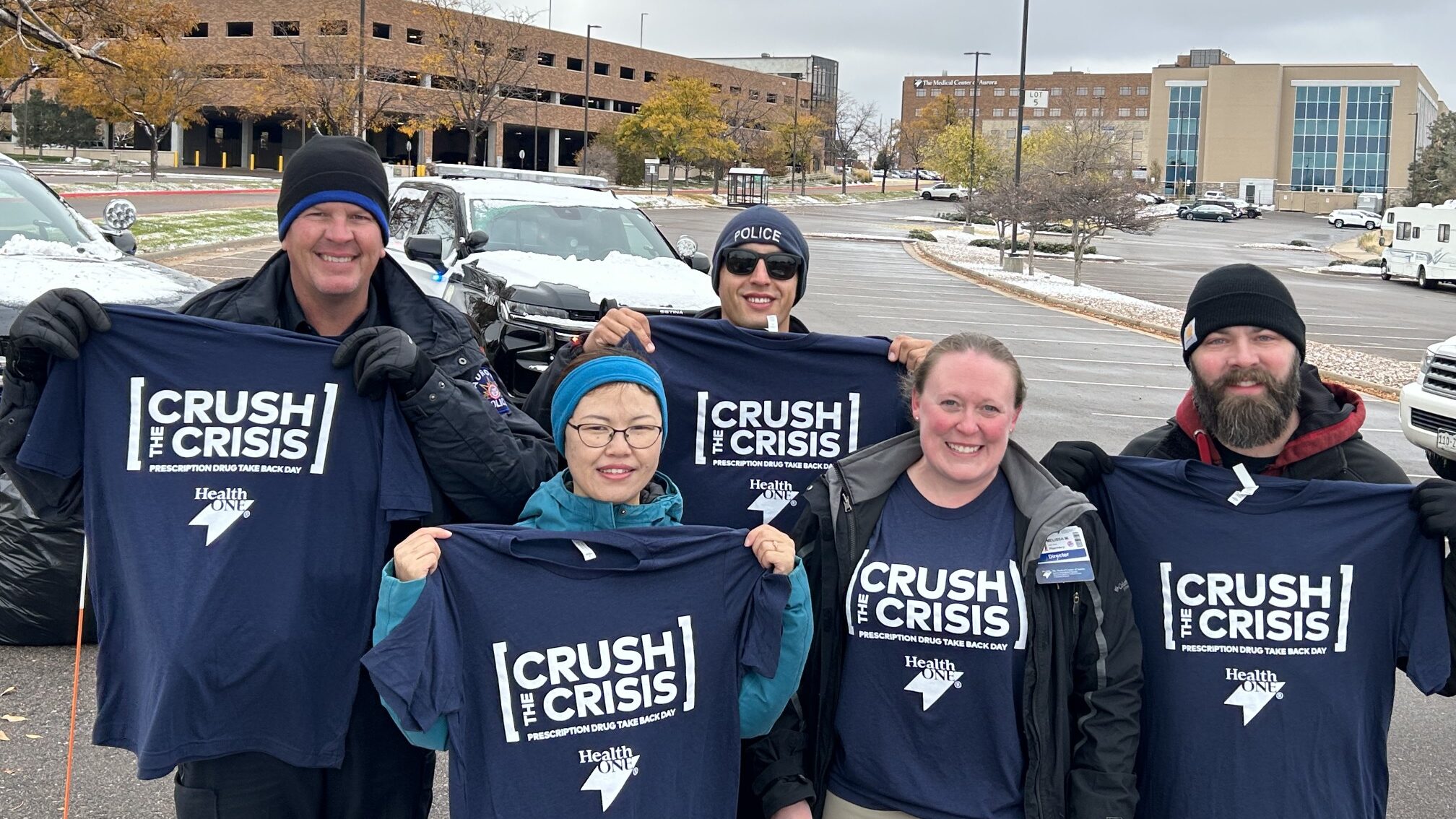 HCA Healthcare colleagues with Crush the Crisis t-shirts in the cold temperatures outside The Medical Center of Aurora