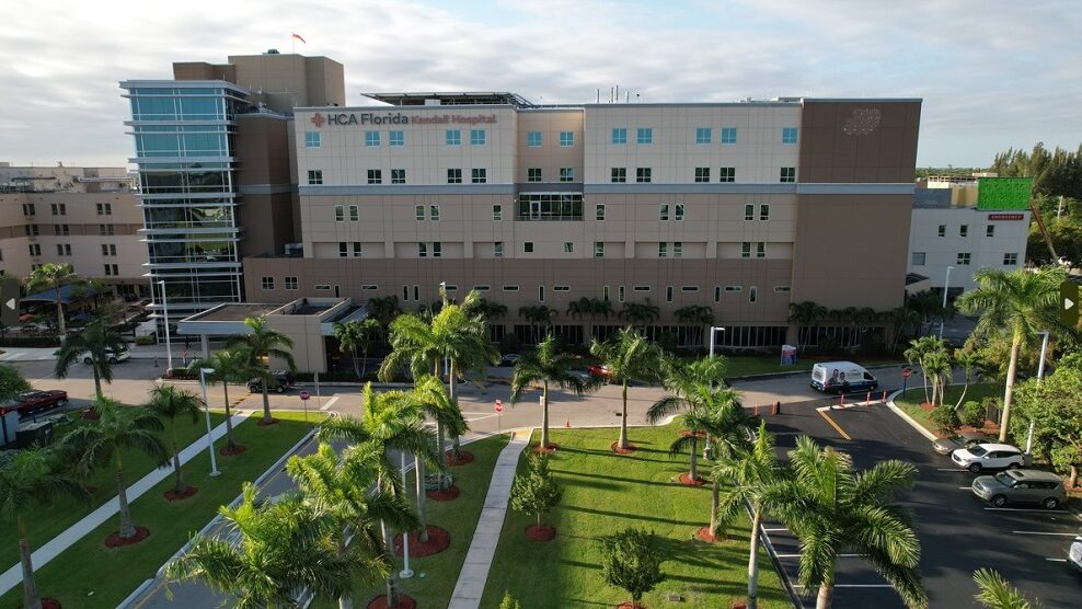 Drone picture of HCA Florida Kendall Hospital with palm trees outside. 